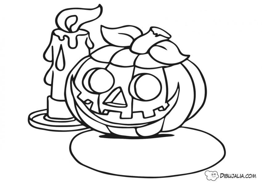 Calabaza junto a una vela